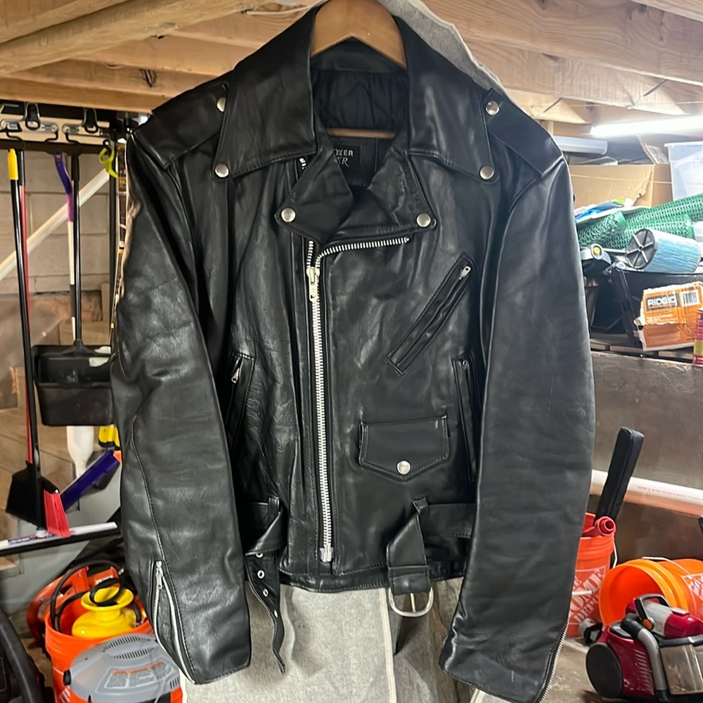 Black leather motorcycle jacket. Size 42 men’s. Brand is “Leather Rider”.